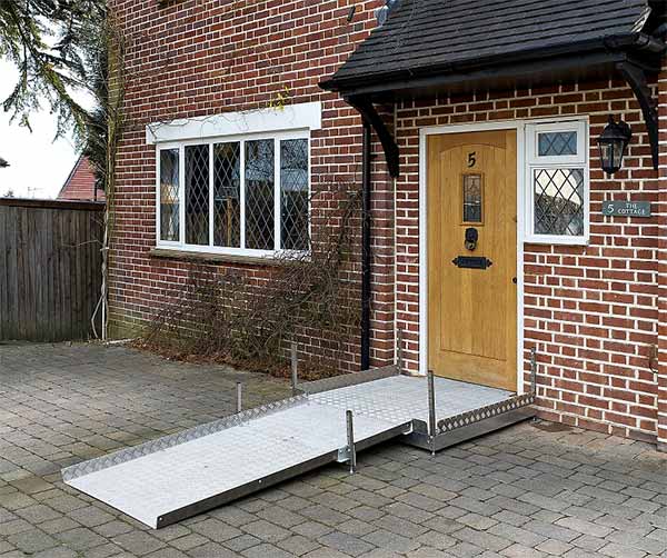 A house with a wheelchair ramp at the door